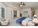 Cozy main bedroom featuring tiled floors, a walk-in closet, backyard views and ensuite bathroom at 5366 Hader Rd, North Port, FL 34288