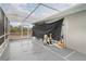 Enclosed pool equipment area featuring a durable, gray painted floor and outdoor views at 5366 Hader Rd, North Port, FL 34288