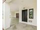Modern home entrance featuring a sleek front door, a dark wood garage door, and clean architectural lines at 8631 5Th Street North, St Petersburg, FL 33702