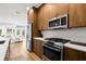 Open kitchen with wood cabinets, stainless appliances, marble backsplash and island opens to the living room at 8631 5Th Street North, St Petersburg, FL 33702