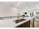 Well-lit kitchen with island, stainless sink, open floor plan to living area with lots of sunlight at 8631 5Th Street North, St Petersburg, FL 33702
