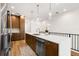 Kitchen with stainless steel appliances, wood cabinets and hardware, and large white quartz countertop at 8631 5Th Street North, St Petersburg, FL 33702
