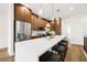 Modern kitchen features wood cabinets, stainless steel appliances, quartz countertops, and island seating at 8631 5Th Street North, St Petersburg, FL 33702
