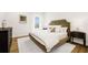 Cozy main bedroom featuring a tufted headboard, plush bedding, and elegant decor at 8631 5Th Street North, St Petersburg, FL 33702