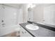 Bright bathroom featuring a large mirror, vanity, and shower-tub combo at 2254 Chianti Pl # 68, Palm Harbor, FL 34683