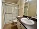 Modern bathroom featuring a glass door walk-in shower, granite counters, updated fixtures, and tiled floors at 2254 Chianti Pl # 68, Palm Harbor, FL 34683