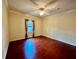 Bright bedroom with hardwood floors, ceiling fan, and window at 2254 Chianti Pl # 68, Palm Harbor, FL 34683