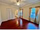 Spacious bedroom with hardwood floors, ceiling fan, natural light, and en-suite bathroom access at 2254 Chianti Pl # 68, Palm Harbor, FL 34683