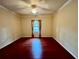 Bright bedroom with hardwood floors, ceiling fan, and window at 2254 Chianti Pl # 68, Palm Harbor, FL 34683
