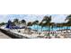 Community lagoon with inflatable slide, palm trees, white sand beach and lounge chairs at 30755 Summer Sun Loop, Wesley Chapel, FL 33545