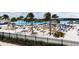 White sand beach lagoon view showcasing umbrellas, lounge chairs, palm trees, and turquoise water at 30755 Summer Sun Loop, Wesley Chapel, FL 33545