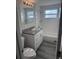 Bathroom with a white sink vanity, white subway tile surround, and gray vinyl plank flooring at 3341 Wiltshire Dr, Holiday, FL 34691