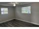 Bedroom with modern flooring and two windows that offer natural light at 3341 Wiltshire Dr, Holiday, FL 34691