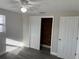 Bedroom with modern flooring, a ceiling fan, and closet with sliding doors at 3341 Wiltshire Dr, Holiday, FL 34691