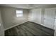 The bedroom has plank flooring, a window, a ceiling fan, and a closet for clothing storage at 3341 Wiltshire Dr, Holiday, FL 34691