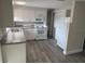 Bright kitchen features stainless steel appliances and white cabinetry with gray counter tops at 3341 Wiltshire Dr, Holiday, FL 34691