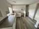 Kitchen features white cabinets and stainless steel appliances at 3341 Wiltshire Dr, Holiday, FL 34691