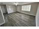 Bright living room with wood-look floors and a large window at 3341 Wiltshire Dr, Holiday, FL 34691