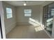 Bright sunroom featuring tile floors, multiple windows, and access to the kitchen at 3341 Wiltshire Dr, Holiday, FL 34691