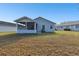 Home exterior featuring a screened porch and tidy backyard at 37401 Wedgewood Dr, Zephyrhills, FL 33542