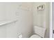 Cozy bathroom with toilet, shelf, and storage cabinet on the wall at 37401 Wedgewood Dr, Zephyrhills, FL 33542