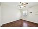 Bright bedroom with hardwood floors, fan, and a sunlit window at 37401 Wedgewood Dr, Zephyrhills, FL 33542