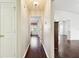 Hallway featuring hardwood floors that leads to a bright bedroom and living spaces at 37401 Wedgewood Dr, Zephyrhills, FL 33542