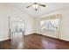 Cozy living room with hardwood floors, a ceiling fan, and sliding doors to the lanai at 37401 Wedgewood Dr, Zephyrhills, FL 33542