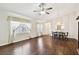 Spacious living room with hardwood floors and dining area with decorative chandelier at 37401 Wedgewood Dr, Zephyrhills, FL 33542