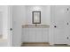 Bathroom vanity featuring granite countertop, and a black framed mirror at 4294 Danbury St, North Port, FL 34286