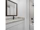 Bathroom features a white vanity with granite countertop, black faucet, and subway tile shower at 4294 Danbury St, North Port, FL 34286