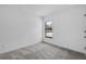 Bedroom with gray carpet, light walls and black framed window at 4294 Danbury St, North Port, FL 34286
