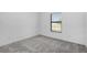 Bedroom featuring neutral carpet, trim, and a window at 4294 Danbury St, North Port, FL 34286