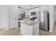 Modern kitchen featuring stainless steel appliances, white cabinetry, and granite countertops at 4294 Danbury St, North Port, FL 34286