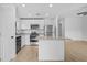 Bright kitchen with stainless steel appliances, white cabinets, and a functional center island at 4294 Danbury St, North Port, FL 34286