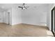 Bright living space with tile floors, ceiling fan, and view into the kitchen area at 4294 Danbury St, North Port, FL 34286