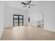 Spacious living area with neutral tile flooring, a ceiling fan, and sliding glass doors at 4294 Danbury St, North Port, FL 34286