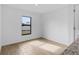Bright, minimalist room with tile flooring and a large window offering natural light at 4294 Danbury St, North Port, FL 34286