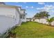 Spacious backyard featuring a manicured lawn, white privacy fence and lush landscaping at 441 42Nd Ne Ave, St Petersburg, FL 33703
