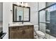 Modern bathroom with dark wood vanity, decorative tile floor, and tiled shower at 441 42Nd Ne Ave, St Petersburg, FL 33703