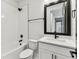 Well-lit bathroom featuring a shower-tub combo, white subway tiles and modern black fixtures at 441 42Nd Ne Ave, St Petersburg, FL 33703