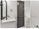 Modern bathroom showcasing a white vanity with black fixtures and view of room at 441 42Nd Ne Ave, St Petersburg, FL 33703