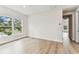 Bedroom features hardwood floors, bright natural light, neutral paint, and a hallway leading to other rooms at 441 42Nd Ne Ave, St Petersburg, FL 33703