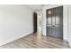 Bedroom with wood floors, gray closet doors, and an open doorway to adjacent room at 441 42Nd Ne Ave, St Petersburg, FL 33703