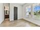 Inviting bedroom featuring wood-look flooring and bathroom views through an open door at 441 42Nd Ne Ave, St Petersburg, FL 33703
