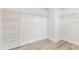 Bright walk-in closet with white walls, wood-look laminate floors, and wire shelving at 441 42Nd Ne Ave, St Petersburg, FL 33703