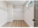 Walk-in closet with laminate flooring, white walls, baseboards, and metal shelving at 441 42Nd Ne Ave, St Petersburg, FL 33703