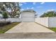 Long concrete driveway leads to a modern home with a white exterior and an attached garage at 441 42Nd Ne Ave, St Petersburg, FL 33703