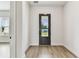 Light and airy entryway features a modern glass door, and stylish wood-look flooring at 441 42Nd Ne Ave, St Petersburg, FL 33703