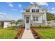Charming two-story home featuring a beautifully landscaped front yard with a welcoming walkway at 441 42Nd Ne Ave, St Petersburg, FL 33703